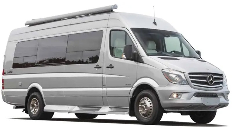 Silver Mercedes-Benz Sprinter van with a retractable awning, showcasing its spacious design ideal for travel or recreational use.